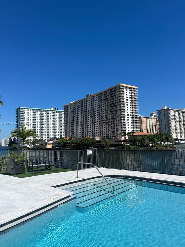 4000 NE 168th St Unit 110A, North Miami Beach, FL 33160 - community pool featuring a patio area and a water view