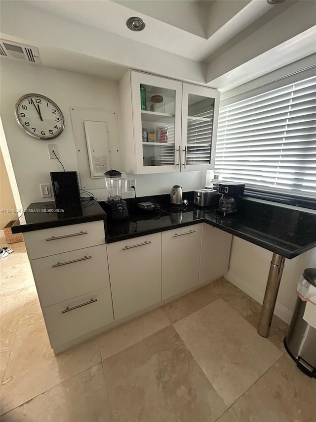 4000 NE 168th St Unit 110A, North Miami Beach, FL 33160 - kitchen with white cabinetry and glass insert cabinets