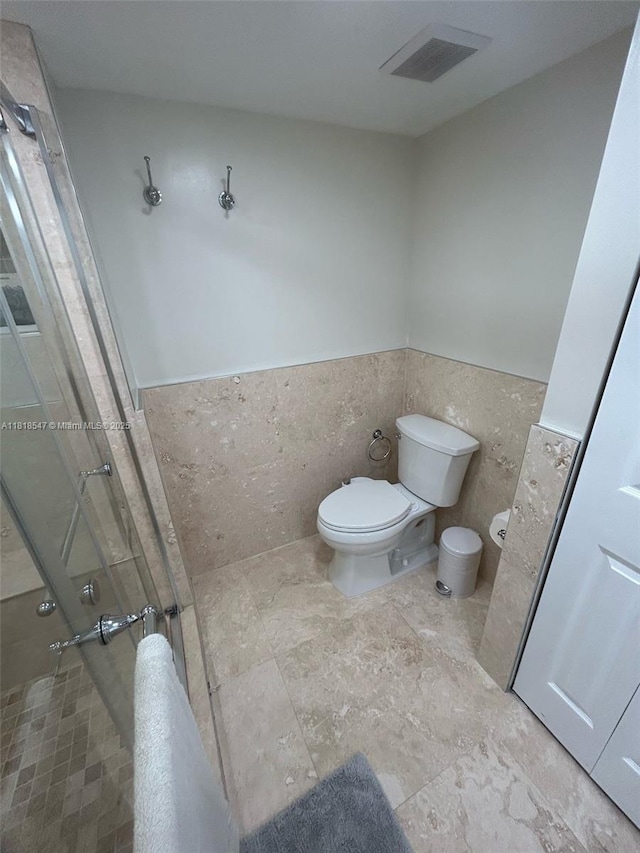4000 NE 168th St Unit 110A, North Miami Beach, FL 33160 - full bath with a shower stall and a wainscoted wall