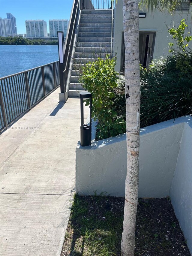 4000 NE 168th St Unit 110A, North Miami Beach, FL 33160 - view of patio with stairway and a water view