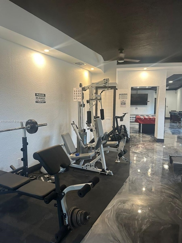 4000 NE 168th St Unit 110A, North Miami Beach, FL 33160 - exercise room with a textured wall and a ceiling fan