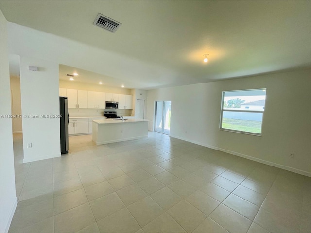 16932 SW 291st St, Homestead, FL 33030 - unfurnished living room with light tile patterned floors and recessed lighting