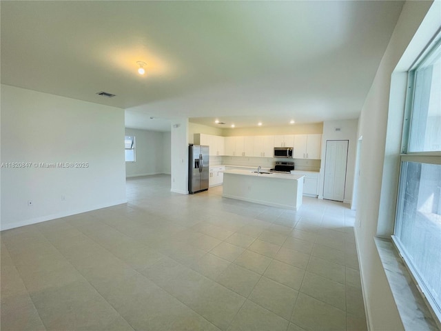 16932 SW 291st St, Homestead, FL 33030 - unfurnished living room with recessed lighting and light tile patterned floors