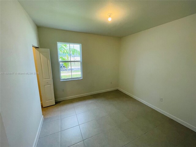 16932 SW 291st St, Homestead, FL 33030 - tiled spare room with baseboards