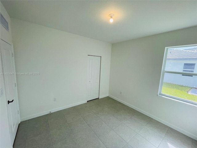 16932 SW 291st St, Homestead, FL 33030 - empty room featuring light tile patterned flooring and baseboards
