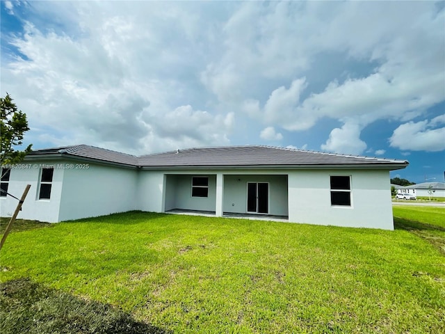 16932 SW 291st St, Homestead, FL 33030 - back of property featuring a lawn, stucco siding, and a patio