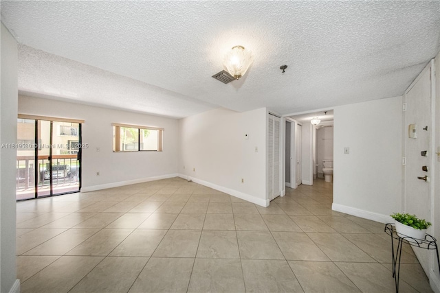 5249 NW 7th St Unit 103, Miami, FL 33126 - empty room with a textured ceiling, light tile patterned floors, and fire sprinkler in ceiling
