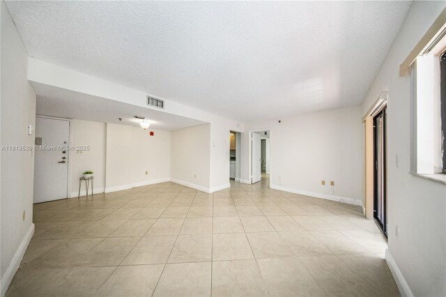 5249 NW 7th St Unit 103, Miami, FL 33126 - unfurnished room with a textured ceiling and light tile patterned floors