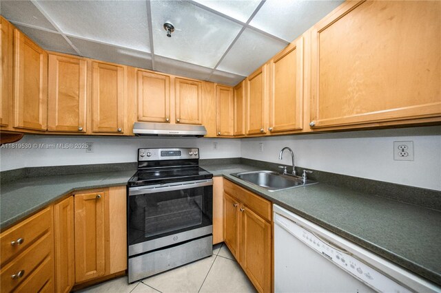 5249 NW 7th St Unit 103, Miami, FL 33126 - kitchen with stainless steel electric stove, under cabinet range hood, dishwasher, light tile patterned floors, and dark countertops