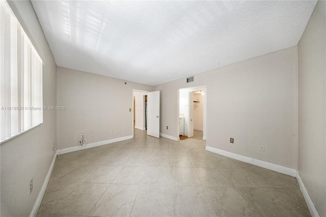 5249 NW 7th St Unit 103, Miami, FL 33126 - empty room featuring baseboards and a textured ceiling