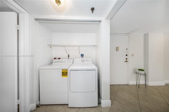 5249 NW 7th St Unit 103, Miami, FL 33126 - laundry room featuring separate washer and dryer, light tile patterned flooring, and a textured ceiling