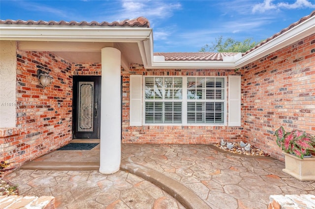 5655 NW 86th Ave, Coral Springs, FL 33067 - property entrance with a tile roof and brick siding