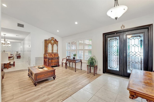 5655 NW 86th Ave, Coral Springs, FL 33067 - entryway featuring french doors, vaulted ceiling, a chandelier, light wood-style floors, and recessed lighting