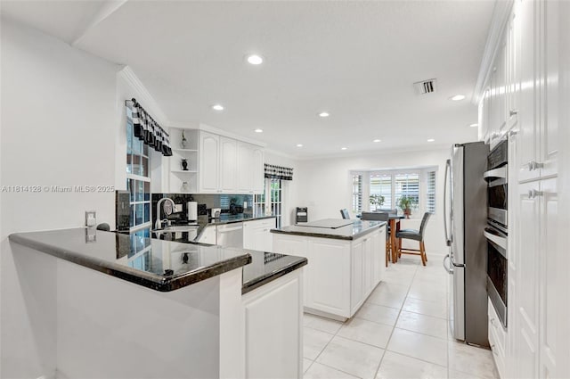 5655 NW 86th Ave, Coral Springs, FL 33067 - kitchen with appliances with stainless steel finishes, open shelves, a center island, a peninsula, and white cabinetry