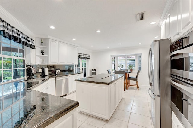 5655 NW 86th Ave, Coral Springs, FL 33067 - kitchen with stainless steel appliances, open shelves, a kitchen island, dark stone counters, and recessed lighting