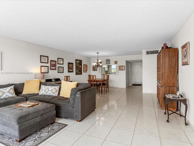 511 Bayshore Dr Unit 309, Fort Lauderdale, FL 33304 - living area featuring a chandelier and a textured ceiling
