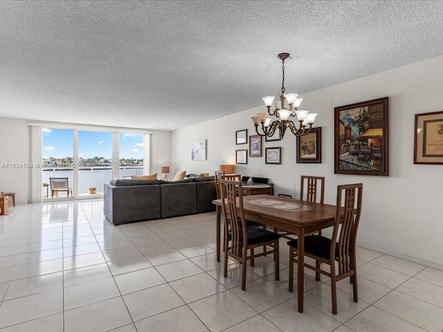 511 Bayshore Dr Unit 309, Fort Lauderdale, FL 33304 - dining space with a textured ceiling, a chandelier, light tile patterned floors, and a water view