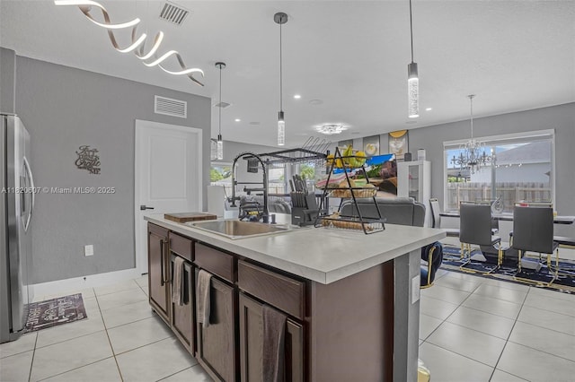 31671 SW 190th Ct, Homestead, FL 33030 - kitchen with freestanding refrigerator, a chandelier, light countertops, pendant lighting, and recessed lighting