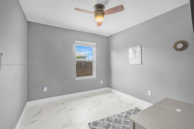 31671 SW 190th Ct, Homestead, FL 33030 - unfurnished room featuring light marble finish floors, ceiling fan, and a textured wall