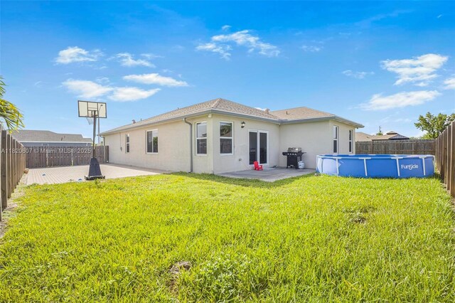 31671 SW 190th Ct, Homestead, FL 33030 - back of house with stucco siding, a fenced backyard, and a patio area