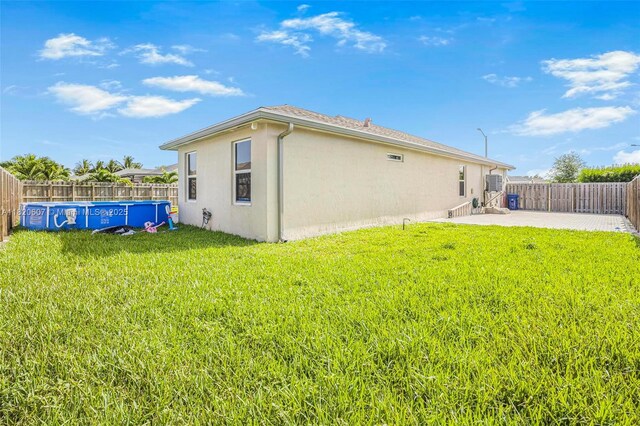 31671 SW 190th Ct, Homestead, FL 33030 - rear view of property with stucco siding, a fenced backyard, and a patio