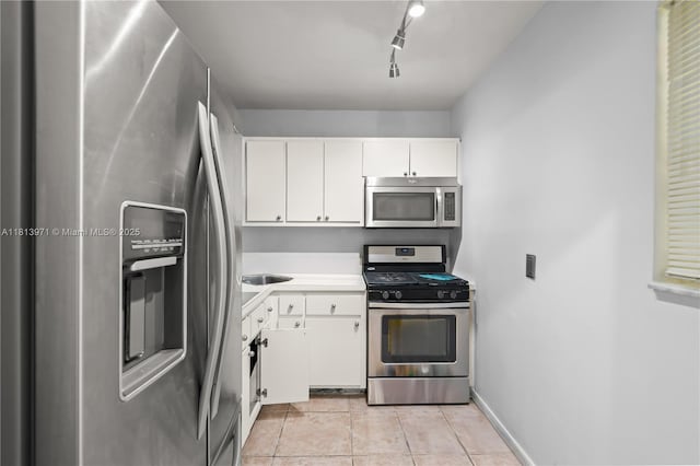 6711 N Kendall Dr Unit 505, Pinecrest, FL 33156 - kitchen featuring stainless steel appliances, light tile patterned flooring, white cabinetry, light countertops, and rail lighting