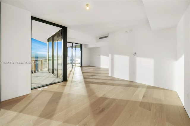 500 Alton Rd Unit 3703, Miami Beach, FL 33139 - spare room with a wall of windows and wood finished floors