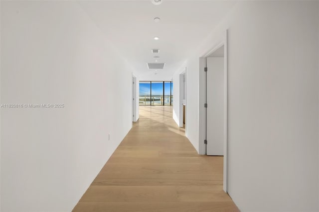 500 Alton Rd Unit 3703, Miami Beach, FL 33139 - corridor with expansive windows, light wood-style floors, and recessed lighting