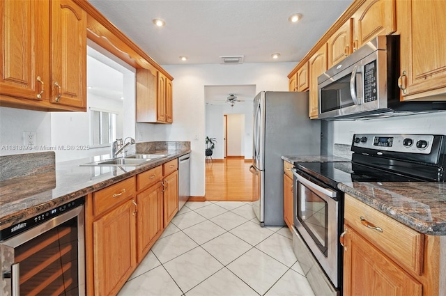 1081 NW 89th Ave, Plantation, FL 33322 - kitchen featuring stainless steel appliances, beverage cooler, light tile patterned floors, dark stone counters, and a ceiling fan