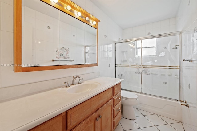 1081 NW 89th Ave, Plantation, FL 33322 - bathroom featuring vanity, combined bath / shower with glass door, tile walls, and tile patterned flooring