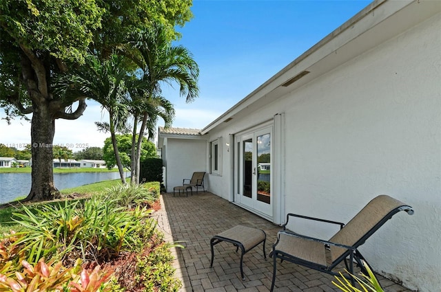 1081 NW 89th Ave, Plantation, FL 33322 - view of patio / terrace featuring a water view and french doors