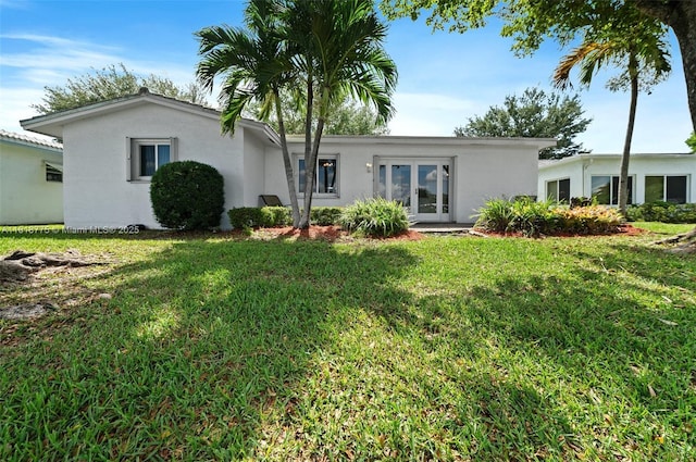 1081 NW 89th Ave, Plantation, FL 33322 - view of front of house with stucco siding, french doors, and a front lawn