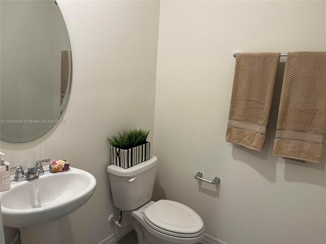 12035 Holystone St, Winter Garden, FL 34787 - bathroom with baseboards and toilet