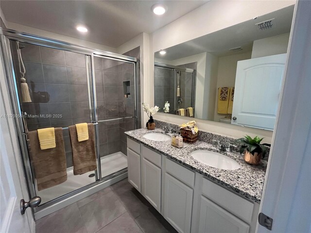 12035 Holystone St, Winter Garden, FL 34787 - full bath with double vanity, a shower stall, tile patterned floors, and recessed lighting