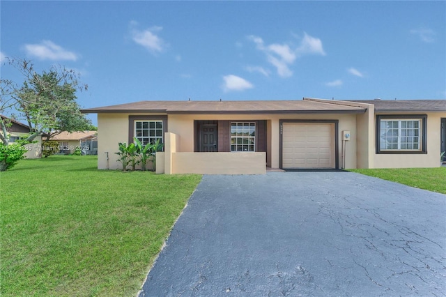 9550 W Heather Ln, Miramar, FL 33025 - ranch-style home with stucco siding, a front yard, driveway, and an attached garage