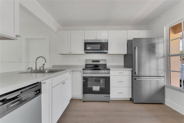 9550 W Heather Ln, Miramar, FL 33025 - kitchen featuring stainless steel appliances, white cabinetry, and plenty of natural light