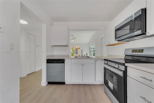 9550 W Heather Ln, Miramar, FL 33025 - kitchen with stainless steel appliances, light wood finished floors, light countertops, and white cabinetry