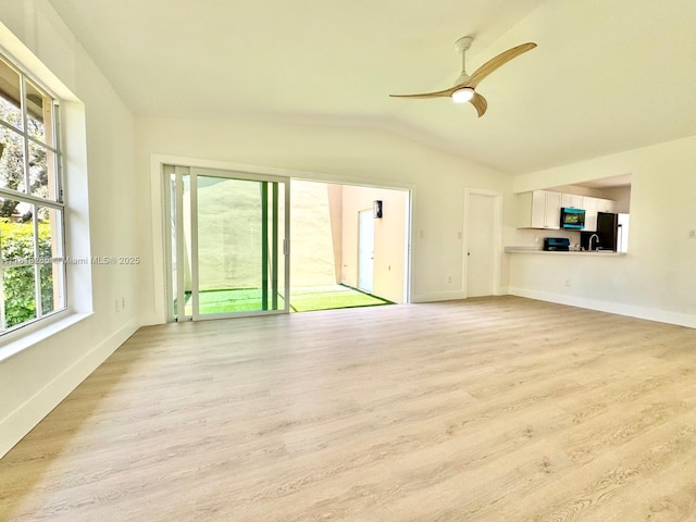 9550 W Heather Ln, Miramar, FL 33025 - unfurnished living room with vaulted ceiling, light wood-type flooring, and a ceiling fan