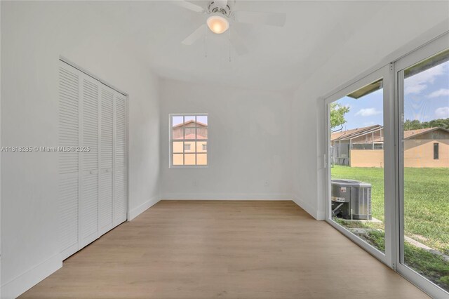 9550 W Heather Ln, Miramar, FL 33025 - unfurnished bedroom featuring access to exterior, wood finished floors, a ceiling fan, and a closet