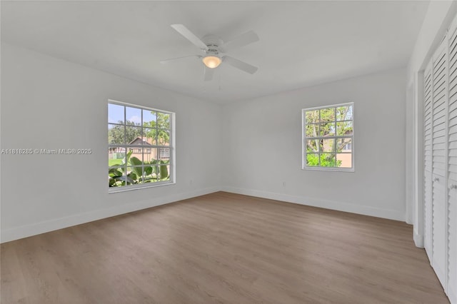 9550 W Heather Ln, Miramar, FL 33025 - unfurnished bedroom with multiple windows and wood finished floors