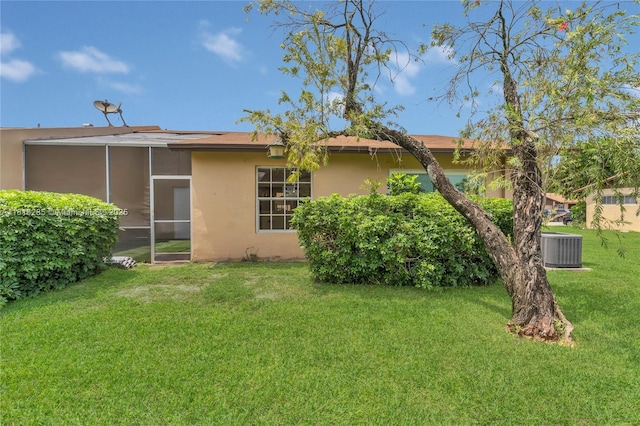 9550 W Heather Ln, Miramar, FL 33025 - back of property with a lawn, a sunroom, and stucco siding