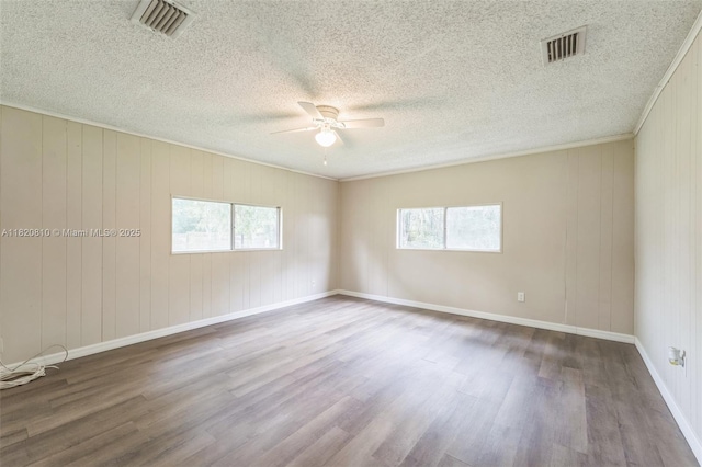 160 SW 9th Ave Fl, Lake Butler, FL 32054 - empty room with wood finished floors, ceiling fan, a textured ceiling, and crown molding