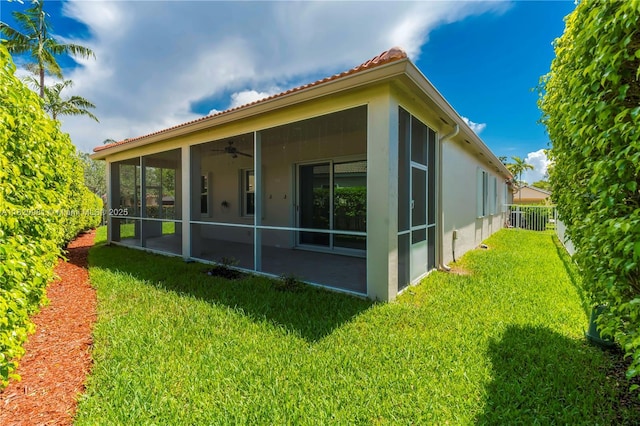 1753 Aspen Ln, Weston, FL 33327 - back of property featuring a sunroom, stucco siding, ceiling fan, and a tile roof