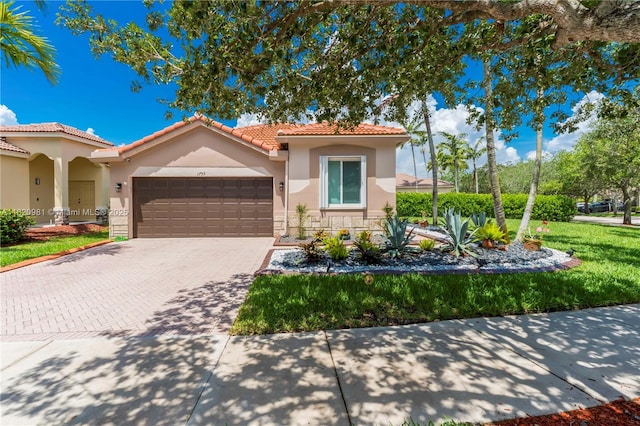 1753 Aspen Ln, Weston, FL 33327 - mediterranean / spanish home featuring stucco siding, an attached garage, a tile roof, driveway, and stone siding