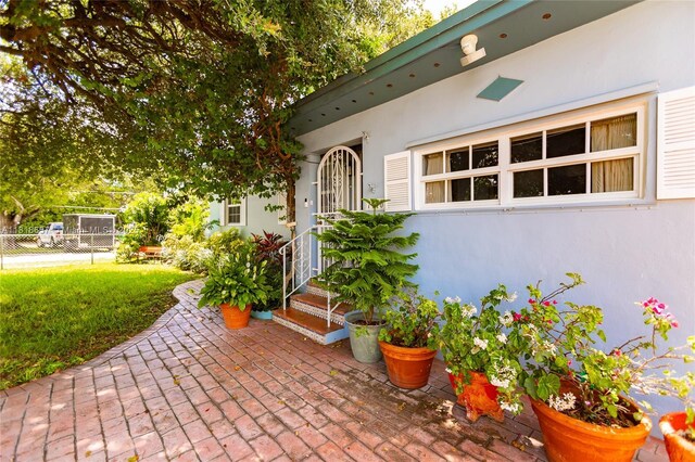 7110 SW 13th Ter, Miami, FL 33144 - doorway to property featuring stucco siding and a patio
