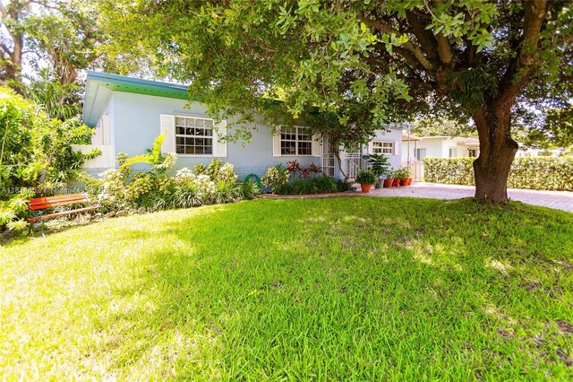 7110 SW 13th Ter, Miami, FL 33144 - view of front facade with a front lawn and stucco siding