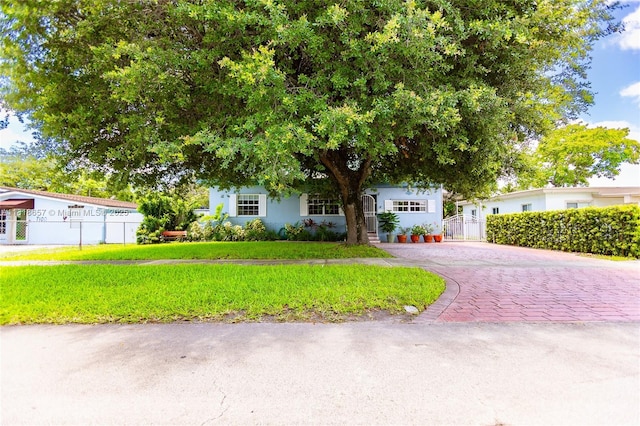 7110 SW 13th Ter, Miami, FL 33144 - obstructed view of property with driveway and stucco siding