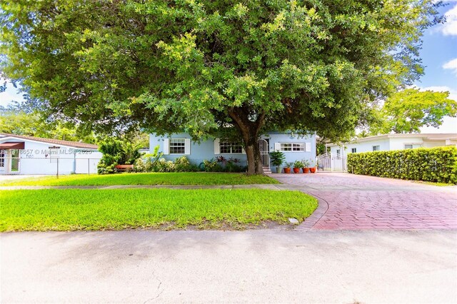 7110 SW 13th Ter, Miami, FL 33144 - obstructed view of property with driveway and stucco siding