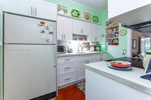 7110 SW 13th Ter, Miami, FL 33144 - kitchen featuring freestanding refrigerator, open shelves, white cabinetry, crown molding, and black electric stovetop