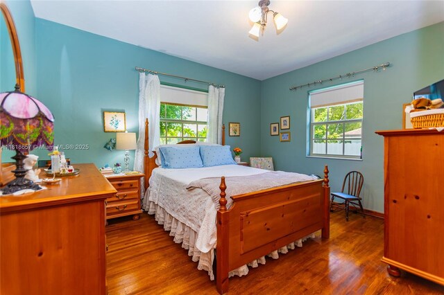 7110 SW 13th Ter, Miami, FL 33144 - bedroom featuring wood finished floors and multiple windows